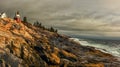 A dramatic panoramic view of a ocean coastline with a lighthouse perched of the cliffs. Royalty Free Stock Photo