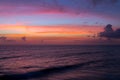 Dramatic pink sunset clouds over water sea