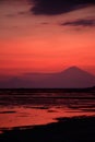 Pink sunset with mount Agung silhouette landscape portrait, Bali Indonesia.