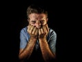 Dramatic portrait of attractive sad and depressed man with hands on his face crying desperate suffering depression and pain having Royalty Free Stock Photo