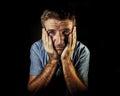 Dramatic portrait of attractive sad and depressed man with hands on his face crying desperate suffering depression and pain having Royalty Free Stock Photo