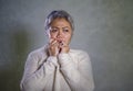 Dramatic portrait of attractive sad and depressed middle aged Asian woman crying helpless suffering depression problem and anxiety Royalty Free Stock Photo