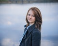 Dramatic portrait of a girl theme: portrait of a beautiful girl on a background of the river Royalty Free Stock Photo