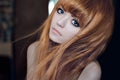 Dramatic portrait of a girl theme: portrait of a beautiful girl with flying hair in the wind against a background in the studio Re Royalty Free Stock Photo