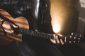 Dramatic portrait of a man playing a guitar. Guitarist