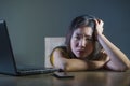 Dramatic portrait scared and stressed Asian Korean teen girl or young woman with laptop computer and mobile phone suffering cyber Royalty Free Stock Photo