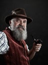 Dramatic portrait of senior smoking tobacco pipe Royalty Free Stock Photo