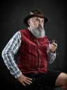 Dramatic portrait of senior smoking tobacco pipe Royalty Free Stock Photo