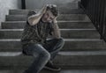 Dramatic portrait of young depressed and paranoid man on dark grunge street corner staircase feeling sick suffering depression and Royalty Free Stock Photo