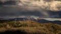 Dramatic rain storm cloud form over the snow mountain