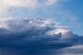 Dramatic rainy clouds on dark blue evening sky. Natural background with stormclouds