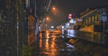 Dramatic rainy night with illuminated street lamps in Atenas city