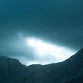 Dramatic rays of light pushing up through clouds