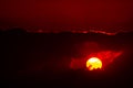 Dramatic red sunset view into rainy clouds