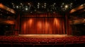 Red theater curtain with spotlight on stage and empty seats in auditorium Royalty Free Stock Photo