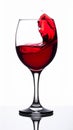 Dramatic Red Wine Splash in Glass Against White Background with Reflections Royalty Free Stock Photo