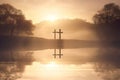 Dramatic religious photo illustration of Easter Sunday Morning reflecting a prayerful moment as a warm sun rises over a foggy lake