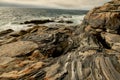 Dramatic rocky shoreline with layered, sculpted formations shaped by centuries of wind and waves. Royalty Free Stock Photo