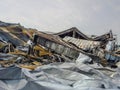 Dramatic scene of a building completely destroyed by a devastating fire, with smoldering debris. Royalty Free Stock Photo