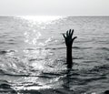 Dramatic scene with the hand of the castaway who is about to drown in the middle of the ocean asking for help