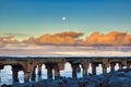 Dramatic scene of Mala Pier at sunrise with moon setting. Royalty Free Stock Photo