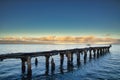 Dramatic scene of Mala Pier at sunrise with moon setting. Royalty Free Stock Photo