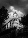 Dramatic scene of an old house under cloudy sky.