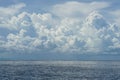 Dramatic scene of powerful white cloud, shades of blue sky background and deep blue sea with ocean water ripple