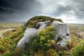 Dramatic scene of a rock with grey clouds