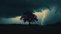 Dramatic scene with a single tree under dark clouds and a bright lightning strike illuminating the sky Royalty Free Stock Photo