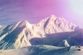 Dramatic scenic pink to purple sunrise in austrian alpine mountain peaks covered with snow layer in winter . Idyllic clear sky on Royalty Free Stock Photo