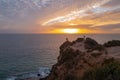 Dramatic scenic rock, seascape. Ocean sunset on sky background with colorful clouds. Calm sea with sunrise sky. Royalty Free Stock Photo