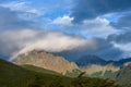 Dramatic scenic view, cloudy sky and early evening sun highlighting mountain peaks, Cerro Alarken Nature Reserve, Ushuaia, Argenti