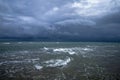 Dramatic seascape in dark colors. Dark sky with clouds over the stormy sea. Royalty Free Stock Photo
