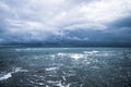 Dramatic seascape in dark colors. Dark sky with clouds over the stormy sea. Royalty Free Stock Photo