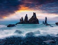 Dramatic seascape of Reynisdrangar cliffs in the Atlantic ocean. Colorful summer sunrise in south Iceland, Vic village location, E