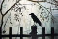 A dramatic shot of a black raven perched on a spooky fencepost