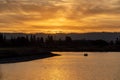 Dramatic shot of people on a paddle boat (pedalo) on the lake at sunset Royalty Free Stock Photo