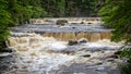 Raging water over series of small waterfalls - long exposure