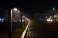 Dramatic shot of an urban nightscape featuring a wide walkway