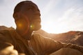 African American Man Sitting on Sand Dune in Desert Royalty Free Stock Photo