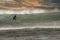Dramaic surfer sihouetted at sunaset on a breaking wave. Royalty Free Stock Photo