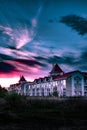 Dramatic sky above the beautiful house at cloudy magenta sunset Royalty Free Stock Photo