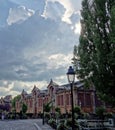 Pretty street scene with amazing storm clouds in Colmar, Alsace, France.