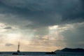 Silhouette of sailboat with Dramatic sky in a tropical sunset. Royalty Free Stock Photo