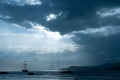 Silhouette of sailboat with Dramatic sky in a tropical sunset. Royalty Free Stock Photo