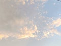 Dramatic sky with clouds, sunlight, and a soft, hazy atmosphere, creating a serene and ethereal landscape.