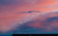 Dramatic sky, colored clouds over rooftop at sunset Royalty Free Stock Photo