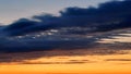 Dramatic sky, dark blue clouds on yellow sunset sky Royalty Free Stock Photo