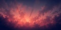 A dramatic sky filled with dark clouds and a vibrant orange and pink sunset glow behind them Royalty Free Stock Photo